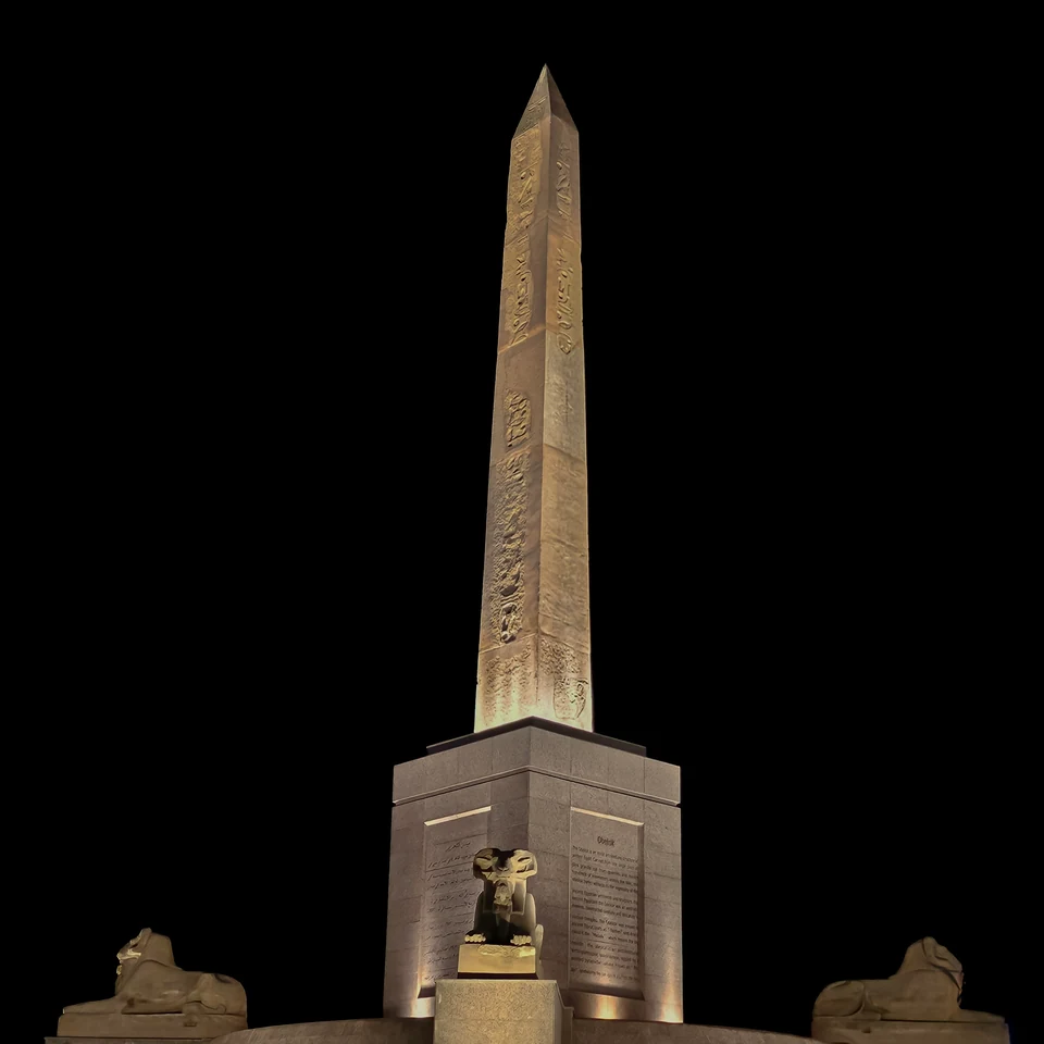 The Ramesses II Obelisk at Tahrir Square in Cairo, illuminated at night against a black sky